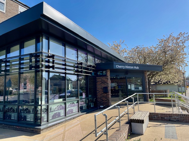 Exterior of Cherry Hinton Hub, the name is written in a sans serif font over the doorway. 